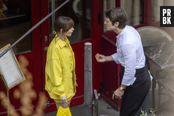 Lily Collins et Lucas Bravo sur le tournage de la saison 4 de série Netflix "Emily in Paris" devant le restaurant L'Esprit de Gigi à Paris, France, le 16 février 2024.