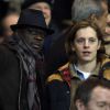 Lilian Thuram et Pierre Sarkozy dans les tribunes du Parc des Princes pour le match PSG-Chelsea, le 17 février 2015