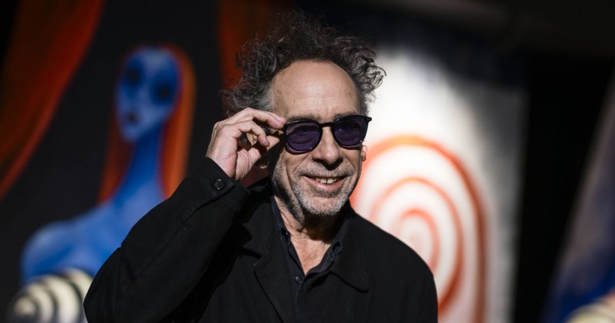 Tim Burton The American filmmaker Tim Burton smiles as he adjusts his ...