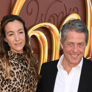 Anna Elisabet Eberstein and Hugh Grant at the premiere of Wonka at the Regency Village Theater in Westwood, California on December 10, 2023.