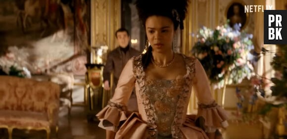 Les images de la bande-annonce de la série "Queen Charlotte : A Bridgerton Story".  Queen Charlotte proves to be a hands-on monarch in sensual new Bridgerton spin-off teaser trailer. Dear readers - and Queen Charlotte fans - now is the time to rejoice. Netflix has unveiled a new look at the Bridgerton origin series Queen Charlotte: A Bridgerton Story, featuring India Amarteifio in the lead role first helmed by Golda Rosheuvel on the preceding series. In the first teaser, a young Charlotte meets her future husband King George III. And while love is very much in the air, it's not without its struggle. "Your marriage is the business of this country," a character in the clip says. "This cannot go wrong." And it's not just love that's at stake - given that Charlotte is ‘the first of her kind’ in the position she's in, she's advised to ‘secure’ her role. "This is my home," Charlotte says. "I am the queen." The series will dive into Queen Charlotte's youth and love life. Now played by Amarteifio, young Charlotte ends up marrying King George III (Corey Mylchreest), cementing her position at the top of the Bridgerton universe. The prequel also stars Michelle Fairley as Princess Augusta, Sam Clemmett as Young Brimsley (with Hugh Sachs as adult Brimsley), Richard Cunningham as Lord Bute, Tunji Kasim as Adolphus, Rob Maloney as the Royal Doctor and Cyril Nri as Lord Danbury. "Many viewers had never known the story of Queen Charlotte before Bridgerton brought her to the world, and I'm thrilled this new series will further expand her story and the world of Bridgerton," Netflix's Head of Global TV, Bela Bajaria, said in a statement. Shonda Rhimes and her team are thoughtfully building out the Bridgerton universe so they can keep delivering for the fans with the same quality and style they love. And by planning and prepping all the upcoming seasons now, we also hope to keep up a pace that will keep even the most insatiable viewers totally fulfilled." Queen Charlotte: A Bridgerton Story is set to premiere May 4, 2023, on Netflix. 