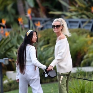 Laeticia Hallyday et ses filles Jade, 15 ans, et Joy, 11 ans, promènent leur chien Cheyenne dans le quartier de Brentwood à Los Angeles, pendant la période de confinement liée à l'épidémie de coronavirus (Covid-19), le 1er avril 2020. 